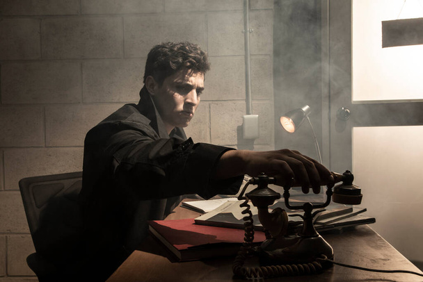 Dark and dramatic scene in a detective's office. heavy smoke. Detective working in a desk - Fotoğraf, Görsel