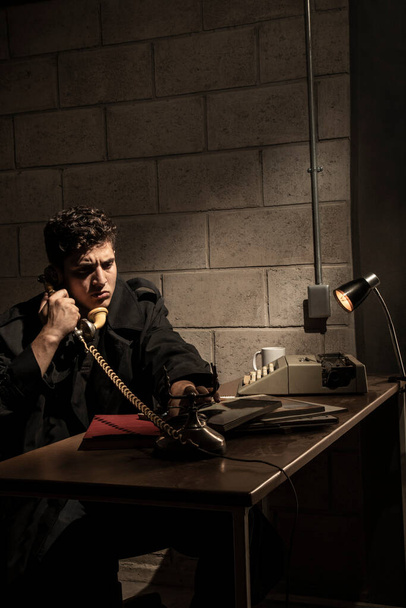 Dark and dramatic scene in a detective's office. heavy smoke. Detective working in a desk - 写真・画像