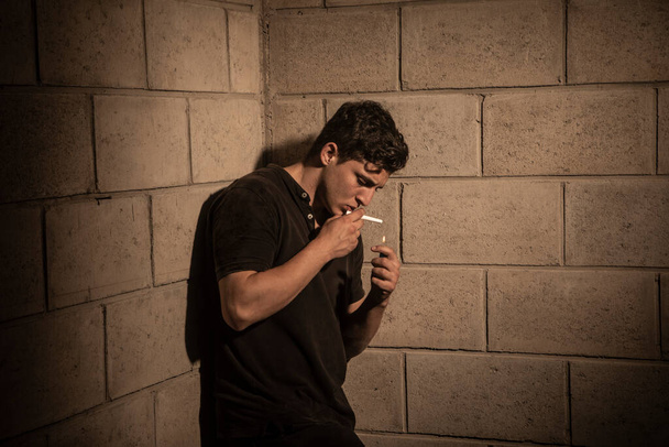 Dark and dramatic scene in a smoking room. heavy smoke. Detective smoking at the room - 写真・画像