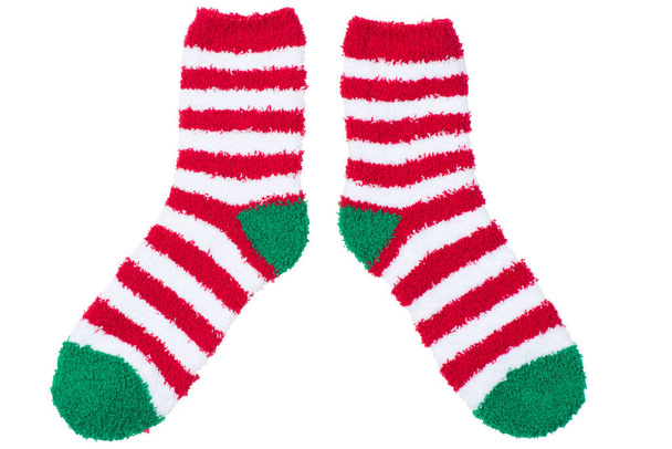 meleg frottír csíkos zokni karácsonyi rajz, forgatás fehér alapon szigetelt - Fotó, kép