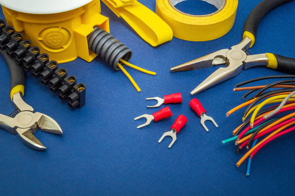 Kit spare parts and tools, wires for electrical prepared before repair or setting on blue background - Foto, Imagen
