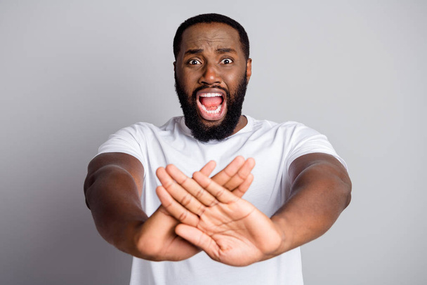 Stop violence. Photo of terrified dark skin american guy protesting against black citizens lawlessness crossing arms stop killing open mouth isolated grey color background - Fotografie, Obrázek