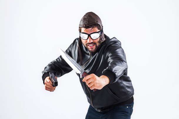 Violent young man holding weapons - 写真・画像