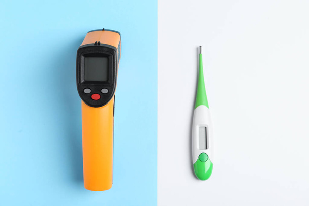 Non-contact infrared and digital thermometers on color background, flat lay - Photo, Image