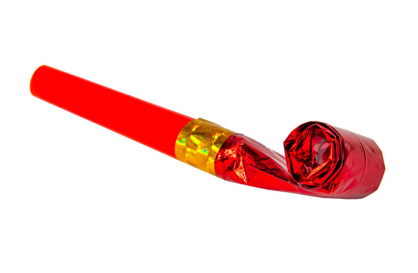 Party red foil whistle or noise maker horn rolled isolated on the white - Photo, Image