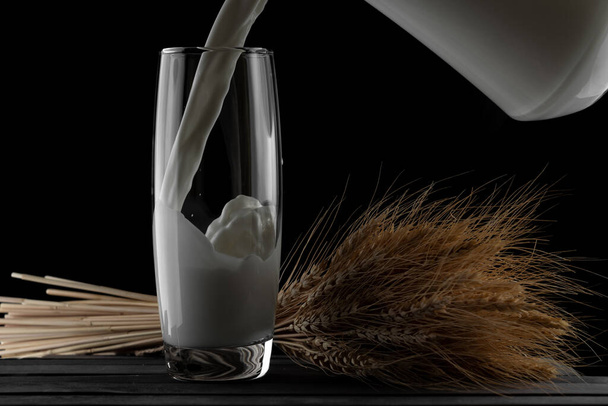 jug of milk and a glass on a black background - Photo, Image