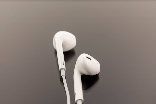 Top view of White Earphones on Black background. Copy space. Music is my life concept - Photo, Image