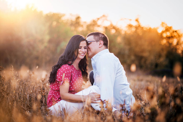 Outdoor portrait of young couple kissing in the afternoon light. Romance, romantic gestures - Fotografie, Obrázek