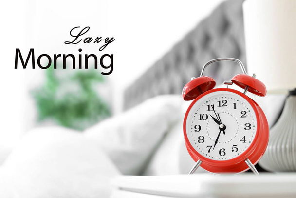 Analog alarm clock on table in bedroom. Lazy morning - Фото, изображение