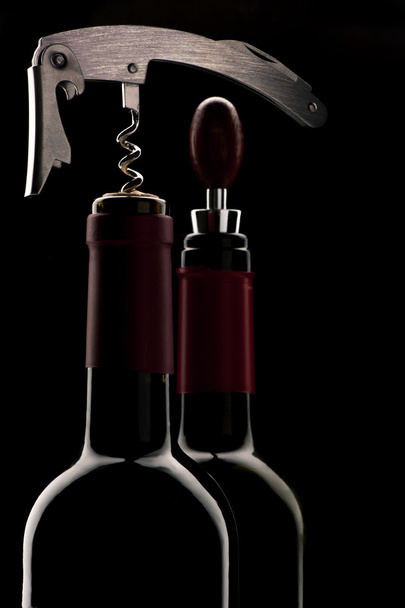 Corkscrew and bottles - Фото, изображение