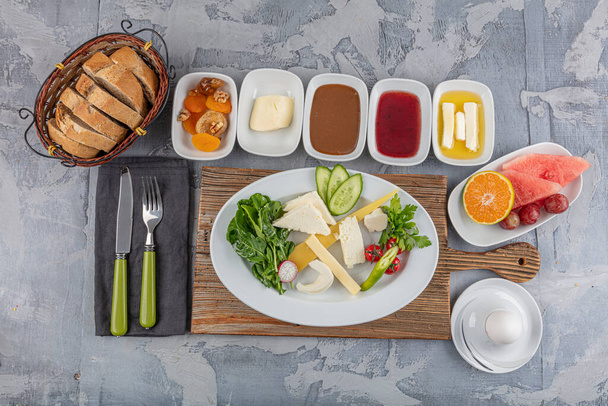 Śniadanie w stylu tureckim; Tradycyjny turecki talerz śniadaniowy na stole, widok z góry. Zdrowe tureckie śniadanie w jasny poranek. - Zdjęcie, obraz