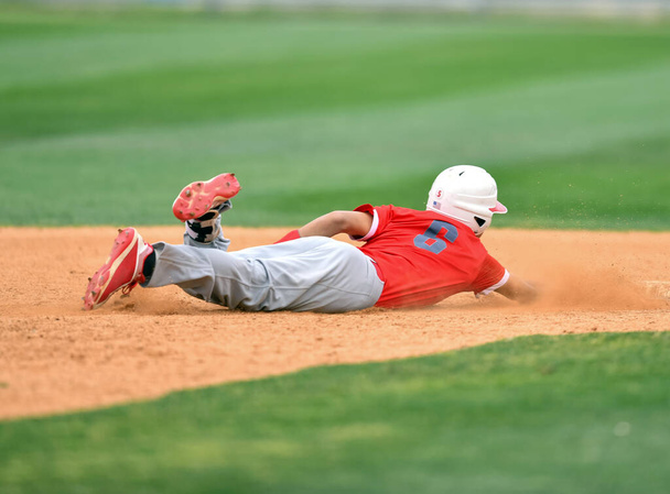 Παίκτης του μπέιζμπολ σε δράση κατά τη διάρκεια ενός παιχνιδιού μπέιζμπολ - Φωτογραφία, εικόνα