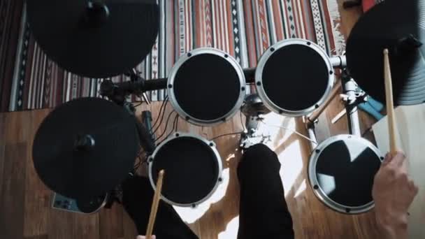 Top view at drummer playing electronic drums at home. Percussion lessons in apartment with sticks. Rock music performance. in 60 fps can be in slow motion - Footage, Video