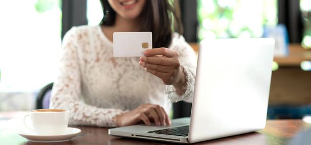 Nuori nainen, jolla on luottokortti ja kirjoittamalla kannettavan verkko-ostoksia ja maksu tekee ostoksen Internetissä, Online-maksu, Business Financial and Technology - Valokuva, kuva