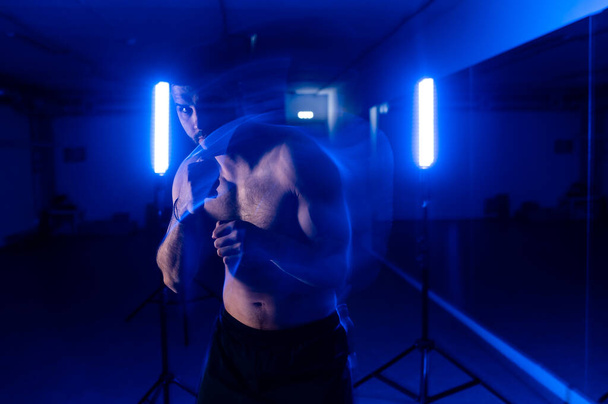 boxer in motion shooting blue light - Foto, Imagem