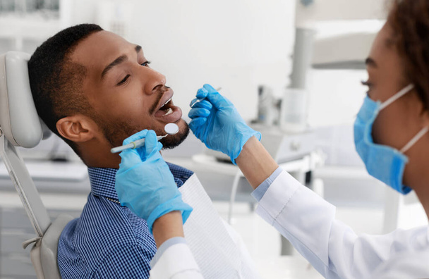 Patient with open mouth having dental treatment - Fotoğraf, Görsel