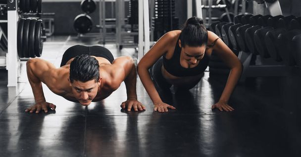caucasian athletics couple workout and exercise with push ups together in gym and fitness health club - Zdjęcie, obraz