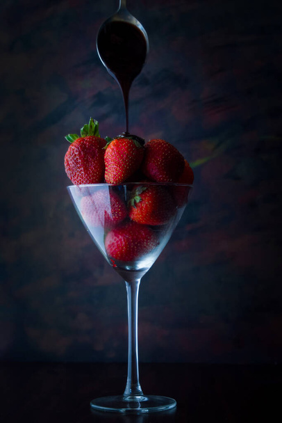 chocolate falls on strawberries in glass - Zdjęcie, obraz