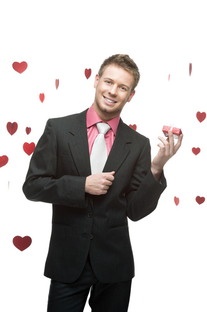 young cheerful businessman holding red gift - Foto, Imagem
