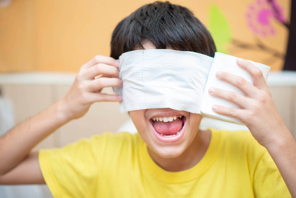 Little boy teen use tissue paper clean in toilet - Fotó, kép