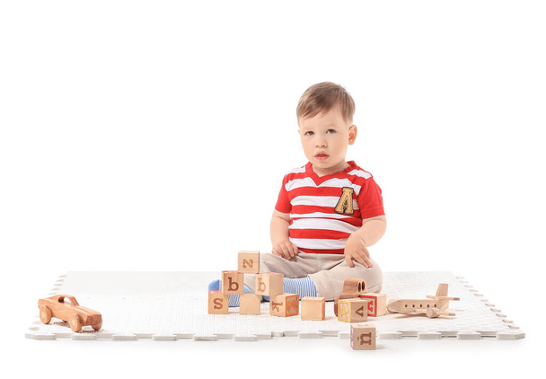Cute little boy with toys on white background - Photo, Image