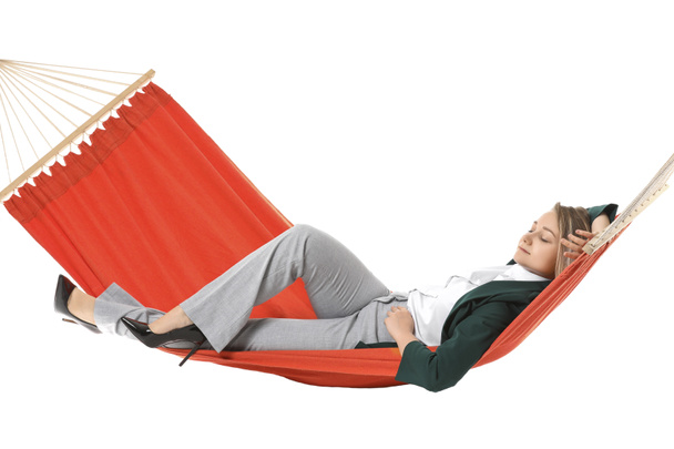 Young businesswoman relaxing in hammock against white background - Photo, Image