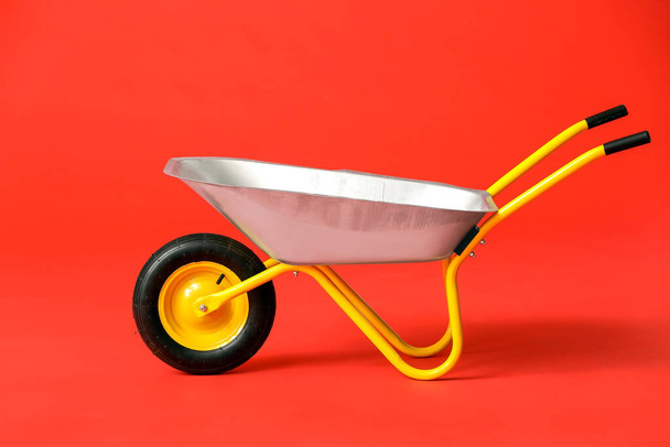 Empty wheelbarrow on color background - Photo, Image