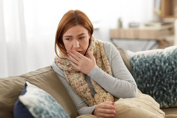sick woman in scarf coughing at home - Foto, Bild