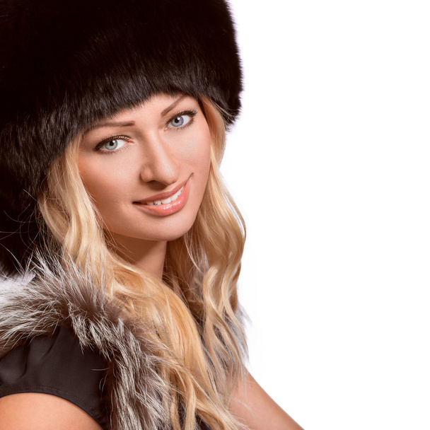 Portrait of beautiful woman in a fur hat - Φωτογραφία, εικόνα