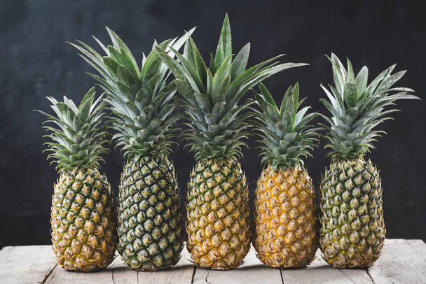 Fresh pineapples on the dark background - Foto, Imagen