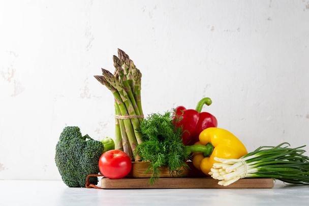 Still life with organic vegetables on white table - Photo, image