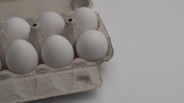 A cell with white chicken eggs. they report a brown egg into it. Alien in society - Video