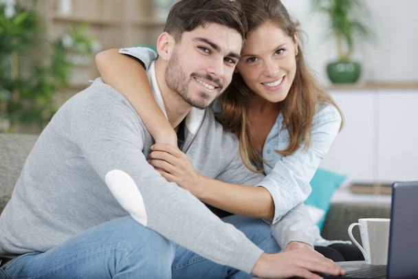 couple hugging and sitting with laptop - Фото, зображення