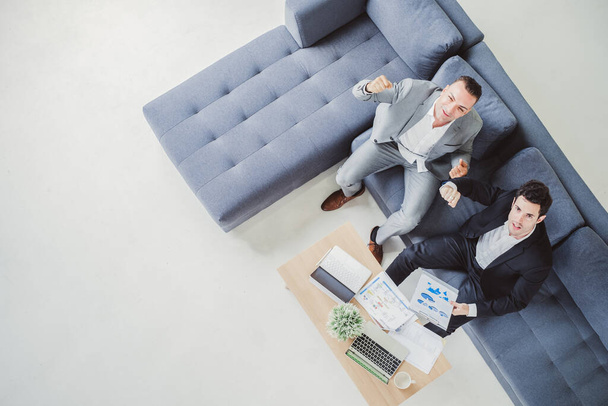Two business man discussing work on table in office, top view - Foto, Imagen