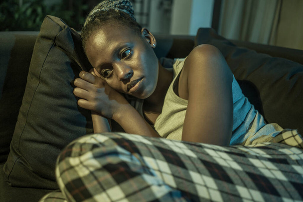 young Afro American woman suffering depression - sad and depressed black teenager girl in pain at home sofa couch feeling overwhelmed and emotional crying lonely in the dark - Fotó, kép