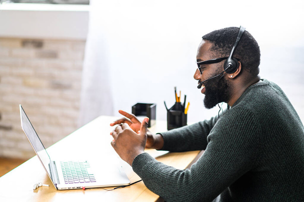 African-American guy with headset using laptop - Photo, Image