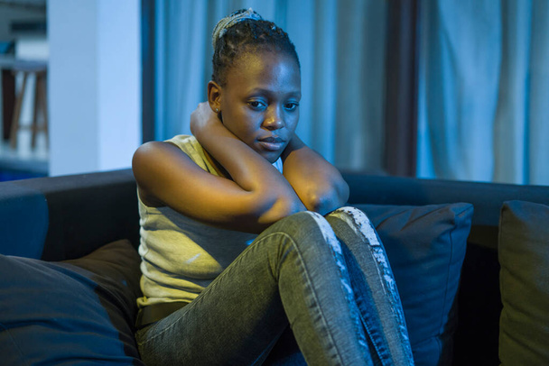 young afro American woman suffering depression - sad and depressed black teenager girl in pain at home sofa couch feeling overwhelmed and emotional crying lonely in the dark - Fotó, kép