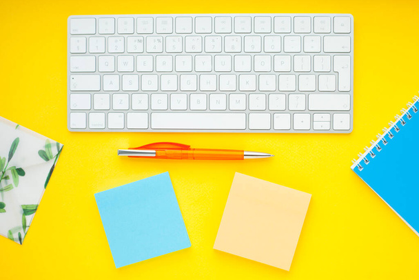 Set of colorful stickers, white keyboard, notebook and snacks. Office table, desk with different objects. Working process. Education, business concept. - Foto, immagini