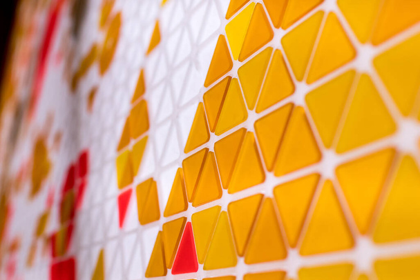 tessellation of a plane with yellow, orange and red colored tria - Φωτογραφία, εικόνα
