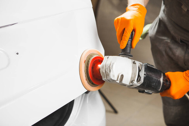 Car polishing in auto repair shop, close-up image. - Foto, immagini