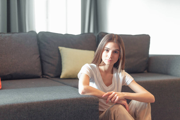 Young woman pretty relaxing on couch in living room. Casual style indoor shoot - Zdjęcie, obraz