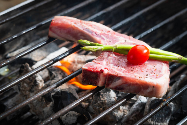 Pork is grilled on the grill. - Foto, imagen