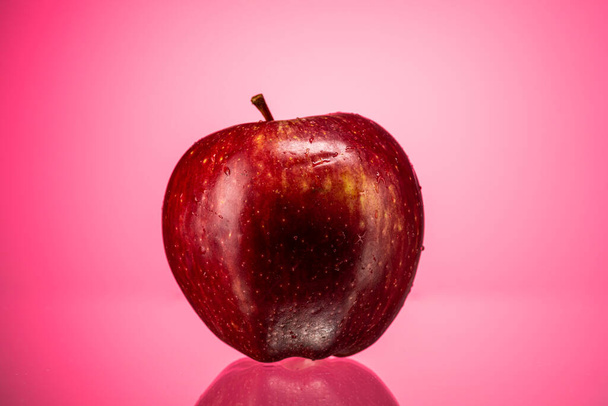 ripe red apple golden simirenko on a red gradient background - Zdjęcie, obraz