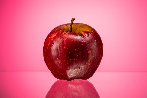 ripe red apple golden simirenko on a red gradient background - Фото, изображение