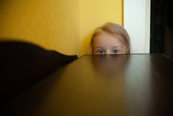  portrait of the eyes of a little girl. Girl peeps out - Zdjęcie, obraz