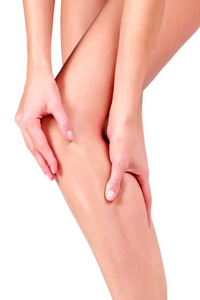 Woman holding sore knee, on white background - Fotografie, Obrázek