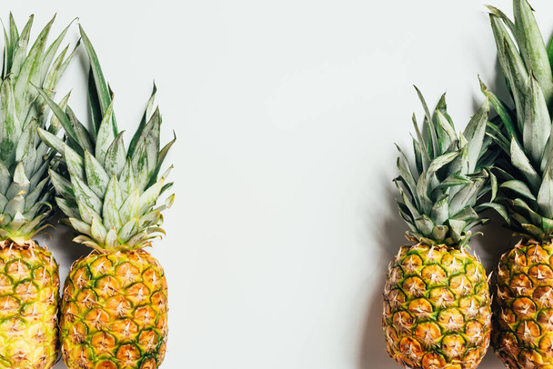 top view of fresh ripe pineapples on white background - Zdjęcie, obraz