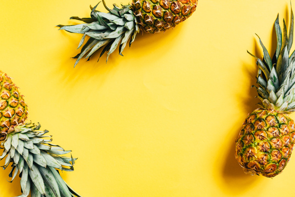 top view of fresh tasty pineapples on yellow background - Photo, Image