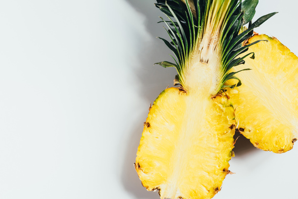 top view of juicy pineapple halves on white background - Fotó, kép