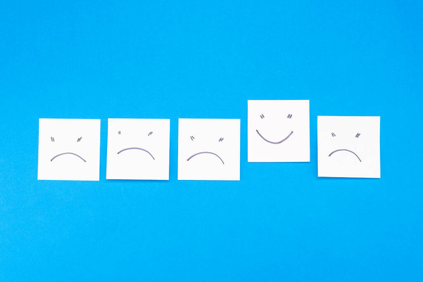 Many stickers - negative and positive emoticon on a blue background - Foto, afbeelding
